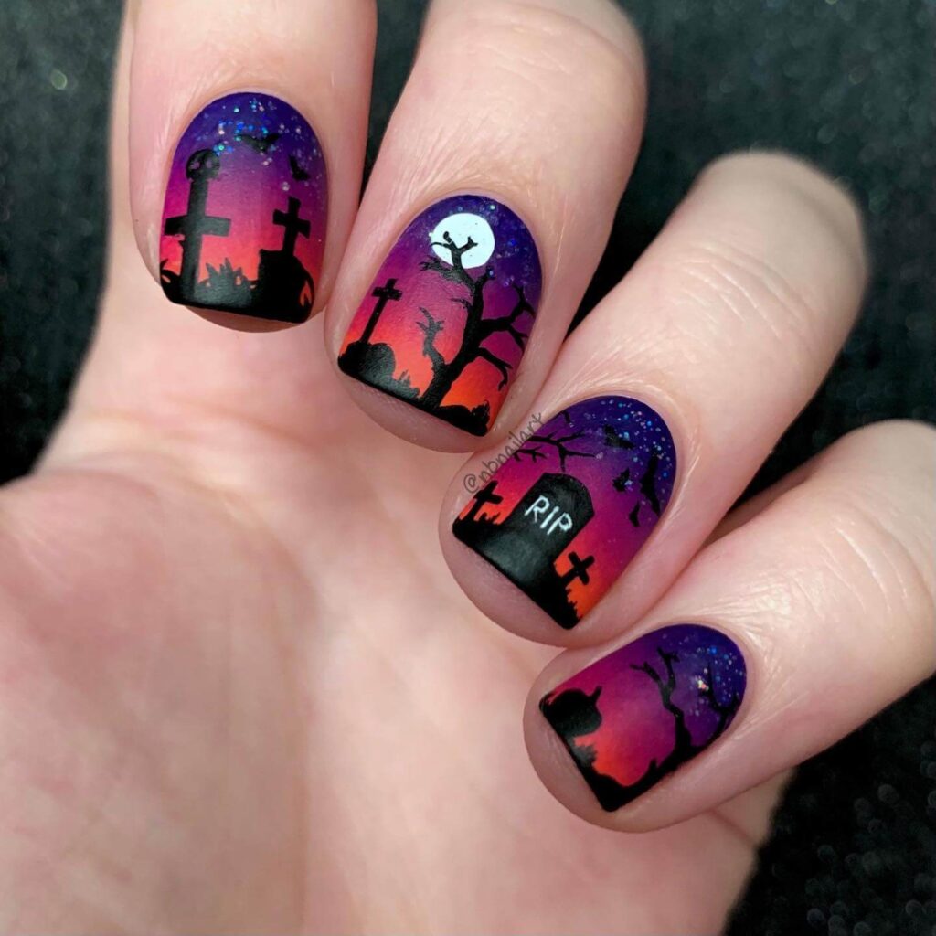 A close-up of elegant dark purple nails with matte purple and ombre nail designs, perfect for both everyday wear and Halloween.