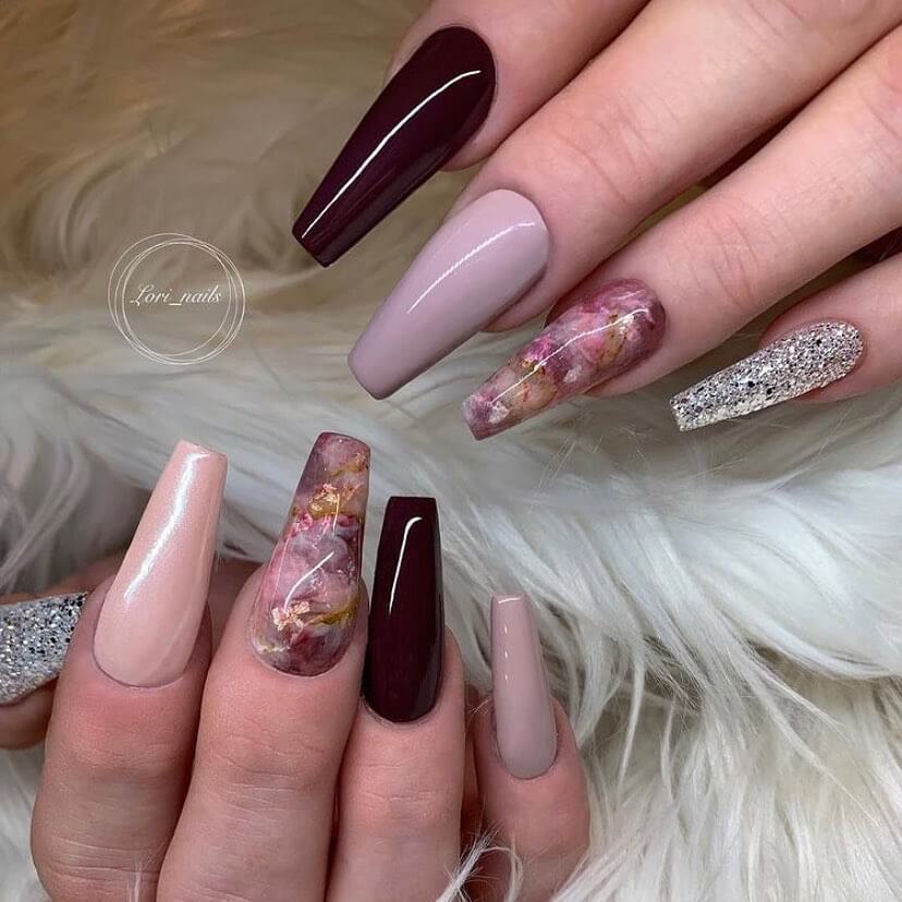 A close-up of elegant dark purple nails with matte purple and ombre nail designs, perfect for both everyday wear and Halloween.