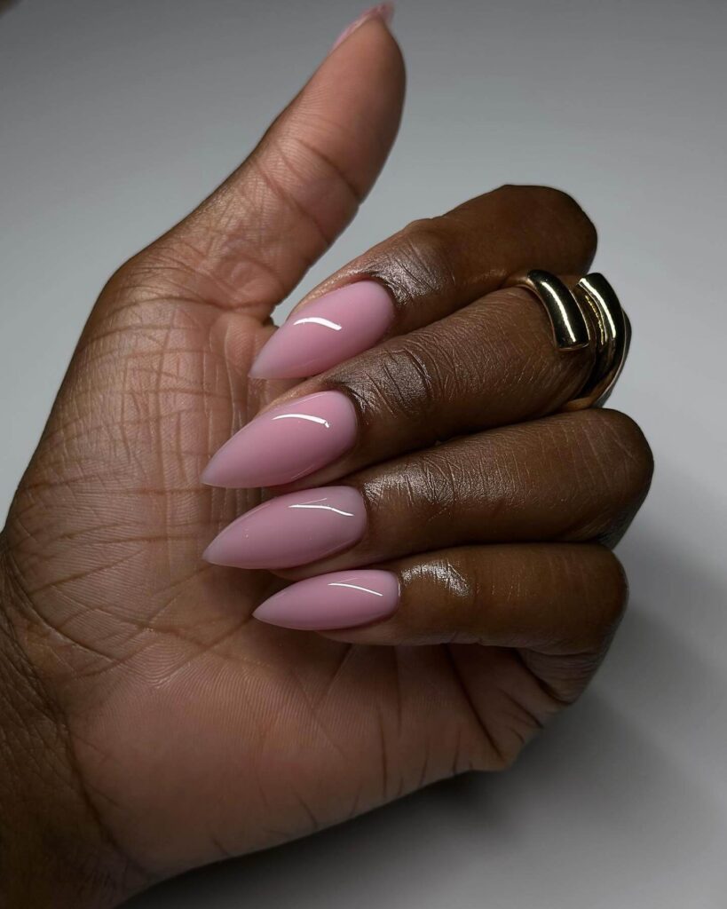 A collection of stiletto nails featuring bold designs, from acrylic and minimalist to glitter and ombre finishes for a dramatic and elegant manicure.