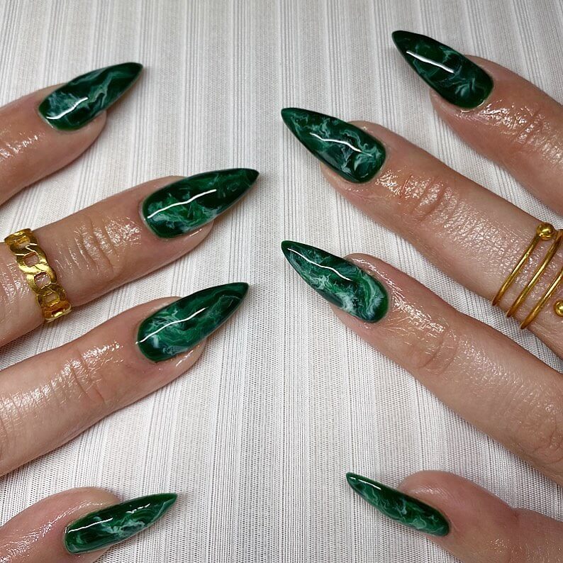 A collection of stiletto nails featuring bold designs, from acrylic and minimalist to glitter and ombre finishes for a dramatic and elegant manicure.